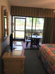 a hotel room with a bed and a table and a view at Grand Lake & Lifetime of Vacations Resorts in Orlando