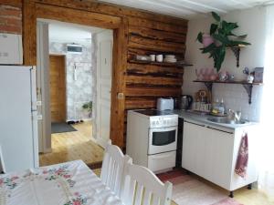 a kitchen with a white stove and a sink at Lille Lux Apartment in Viljandi
