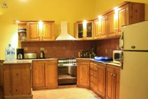 a kitchen with wooden cabinets and a white refrigerator at Dahabcastle in Dahab