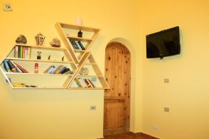 a room with bookshelves and a tv on a wall at Dahabcastle in Dahab