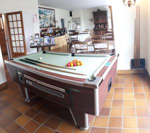 a pool table with fruit on top of it at Hotel Ker Vennaik in Bénodet