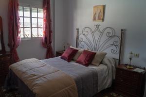 Säng eller sängar i ett rum på Casa La Biznaga
