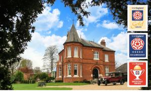 a large red brick building with a turret at Little Redlands B&B in Lincoln