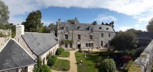 an aerial view of a large stone house with a yard at Manoir du Moustoir - Hôtel Les Empreintes in Saint-Évarzec
