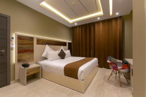 Ένα ή περισσότερα κρεβάτια σε δωμάτιο στο MADAURE HOTEL