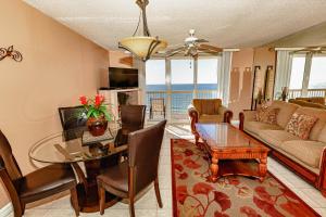 a living room with a couch and a table with a dining room at Pelican Pointe in Destin