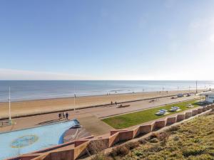 a view of a beach with a swimming pool and the ocean at Southpoint in Bridlington