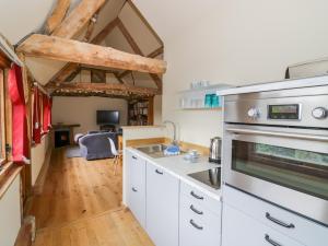 a kitchen with a sink and a stove top oven at Ryepiece Cottage in Stratford-upon-Avon