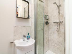 a bathroom with a sink and a shower at SeaSound in Ilfracombe +7 photos