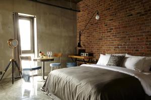 a bedroom with a brick wall and a bed at Hotel Lacky Daejeon in Daejeon