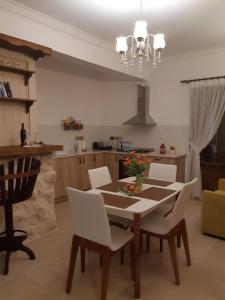 a dining room table and chairs in a kitchen at Doga Apartment in Famagusta