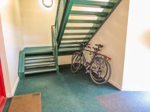 a bike is parked next to a staircase at 12 Keathbank Court in Blairgowrie