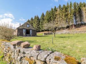 a stone wall in front of a stone house at Thompson Rigg Barn in Scarborough