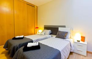 A bed or beds in a room at Apartamentos Albero