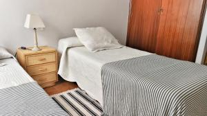 Postel nebo postele na pokoji v ubytování Apartamento Rías Baixas - 1a Línea Playa Raxó