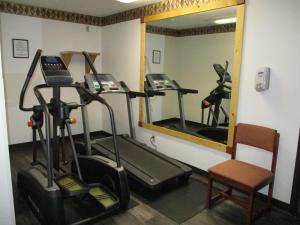 a gym with two tread machines and a mirror at Heritage Inn Express in Marysville