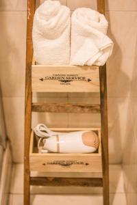 a towel rack with towels and a bottle on it at B&b Stazione La Reggia in Caserta