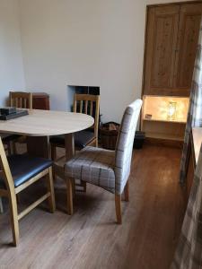 a dining room with a table and chairs at Cliff Cottage in Kyle of Lochalsh