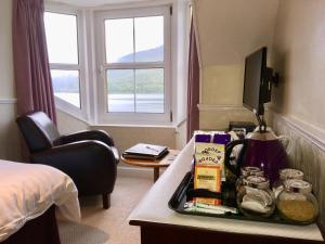 a hotel room with a tray of food on a table at TwoStones in Arrochar