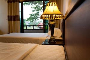 A bed or beds in a room at Kong Garden View Resort Chiang Rai