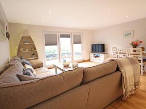a living room with a large couch and a table at The Bay in Trearddur