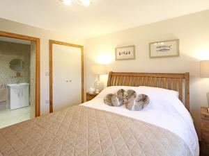 a bedroom with a bed with two shoes on it at The Bay in Trearddur