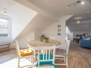 a dining room with a table and chairs at The Towers - Castell in Criccieth +18 photos