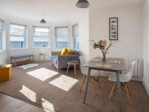 a living room with a table and a couch at The Towers - Ardudwy in Criccieth