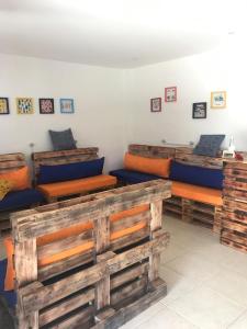 a room with four beds in a room at Hostel Ares do Mundo in Miguel Pereira