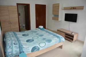 a bedroom with a bed with a blue and white comforter at Villa Dudanov in Ohrid