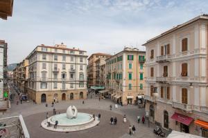 a group of people walking around a city street at Blu Sea Rooms in La Spezia