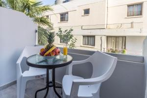 a table topped with a chair and a table cloth at Paul Marie Hotel Apartments in Ayia Napa
