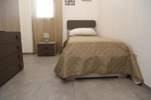 Ένα ή περισσότερα κρεβάτια σε δωμάτιο στο Casa Vacanza Nonno Pippi