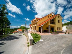 a large yellow building on the side of a street at Apartments Oltari in Sveti Juraj