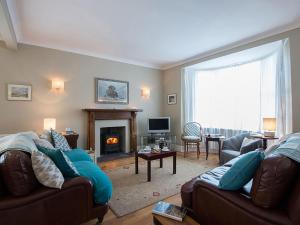 a living room with a couch and a fireplace at West View in Rhosneigr