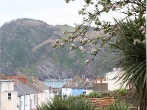 a group of houses in front of a mountain at 10 Cove View in Ilfracombe