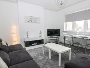 a living room with a couch and a table at Angel by the Sea in Bridlington