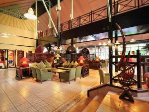 a lobby with couches and chairs in a building at Senegambia Beach Hotel in Sere Kunda NDing