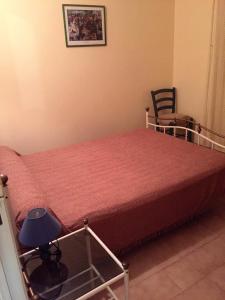 a bedroom with a bed and a chair in a room at gîtes de corse in Ventiseri