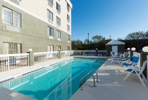 a swimming pool in front of a building at La Quinta Inn by Wyndham North Myrtle Beach in Myrtle Beach