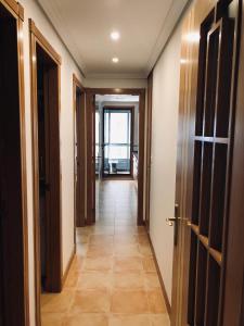 a hallway with doors and a tile floor at Apartamento Único in Vigo