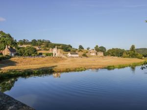 a view of a river with houses in the background at The Cottage at Manor Farm in York