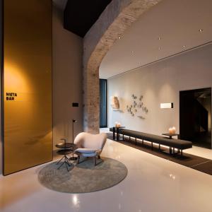 a living room filled with furniture and a large mirror at Caro Hotel in Valencia