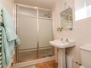 a bathroom with a shower and a sink at Upper Barn Cottage in Minehead +18 photos