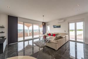 a living room with a couch and a table at Villa Luka in Zadar