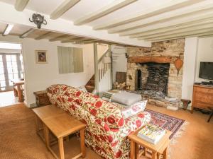 a living room with a couch and a fireplace at Fountain View Cottage in Upper Heyford