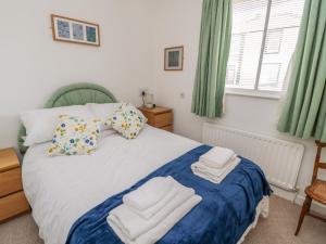 a bedroom with a bed with towels on it at The Wynd Apartment in Morpeth