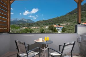 a table and chairs on a balcony with a view at Princess Golden Beach Hotel in Chrysi Ammoudia
