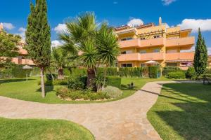 a resort with a pathway in front of a building at Wonderful apartment 5 minutes flat walk to the Centre of La Cala de Mijas in La Cala de Mijas