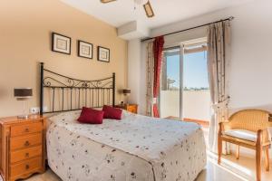 a bedroom with a bed and a large window at Wonderful apartment 5 minutes flat walk to the Centre of La Cala de Mijas in La Cala de Mijas